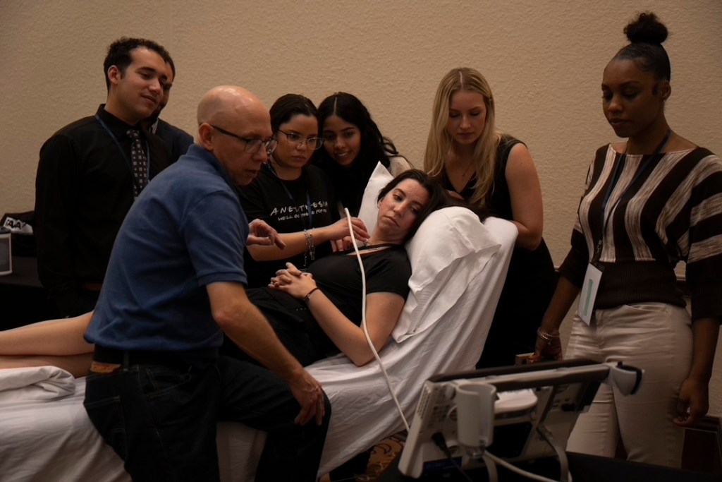 Participants learning ultrasound scanning with Block GuRU faculty